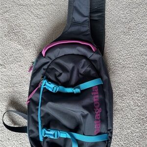 Patagonia Atom 8 Black Sling Bag with Blue and Pink Details
